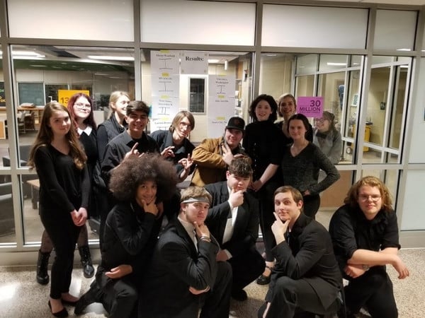 Choir members posing theatrically for camera