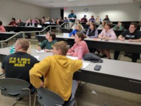 JETS members listening to speaker in classroom