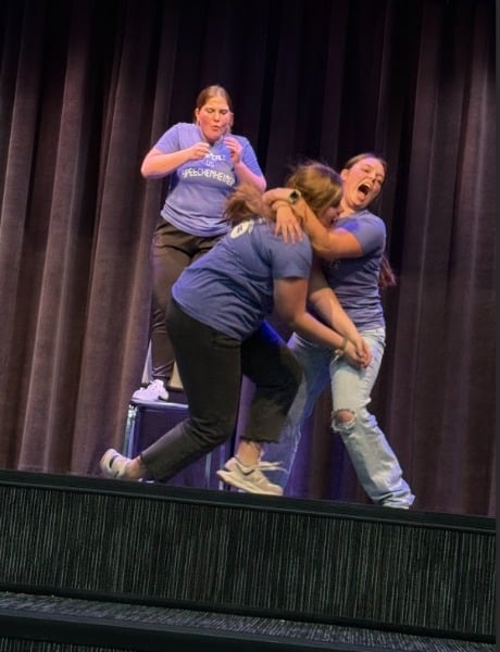 Three girls performing a skit